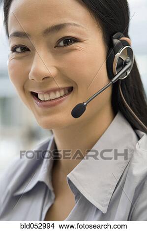 Asian businesswoman wearing headset View Large Photo Image Picture - Asian businesswoman wearing headset. Fotosearch