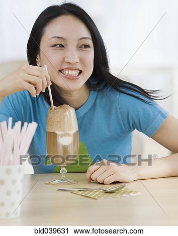 Asian woman drinking milkshake View Large Photo Image Stock Image - Asian woman drinking milkshake. Fotosearch