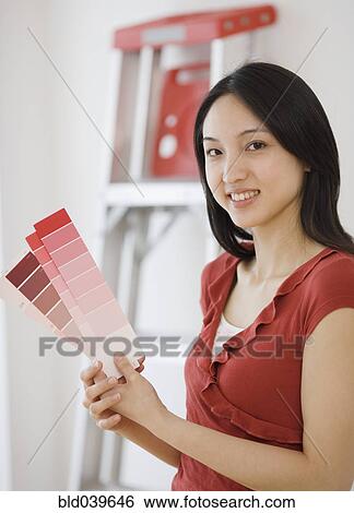 Asian woman holding paint samples View Large Photo Image Stock Photograph - Asian woman holding paint samples. Fotosearch