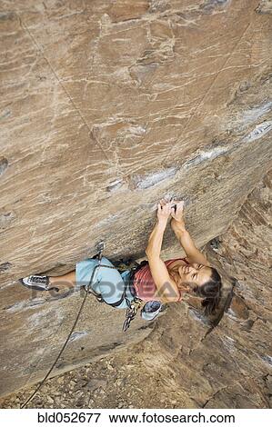 Stock Photo - Asian woman rock climbing. Fotosearch