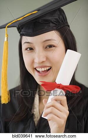 Asian woman wearing graduation cap and holding diploma View Large Photo Image Stock Image - Asian woman wearing graduation cap and holding diploma. Fotosearch