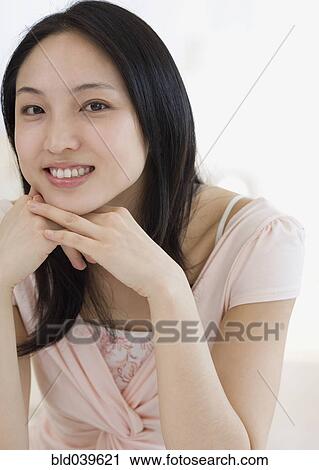 Asian woman with chin on hands View Large Photo Image Stock Image - Asian woman with chin on hands. Fotosearch