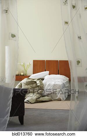 Bedroom with unmade bed View Large Photo Image Stock Image - Bedroom with unmade bed. Fotosearch