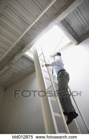Businessman climbing ladder to roof View Large Photo Image Stock Photography - Businessman climbing ladder to roof. Fotosearch