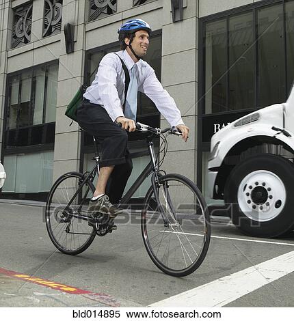 Stock Photography - Businessman commuting on bike. Fotosearch
