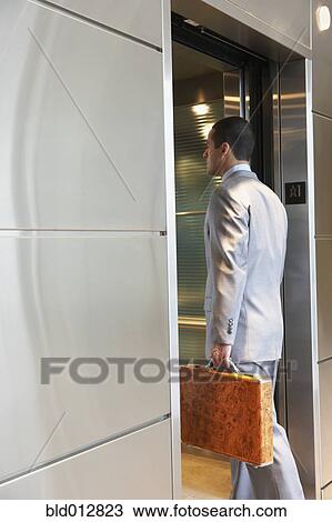 Businessman entering elevator View Large Photo Image Stock Image - Businessman entering elevator. Fotosearch