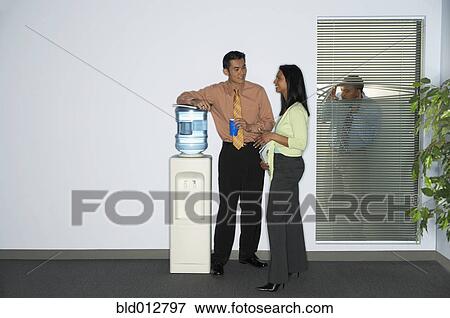 Stock Photo - Businessman spying on coworkers. Fotosearch