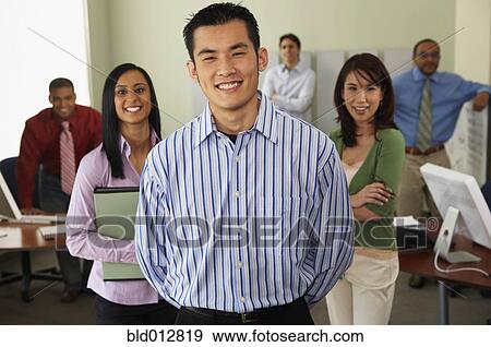 Stock Photo - Businessman with coworkers in background. Fotosearch