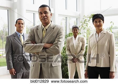 Stock Photo - Businessman with coworkers in background. Fotosearch