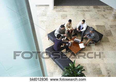 Businesspeople meeting in lobby View Large Photo Image Stock Photograph - Businesspeople meeting in lobby. Fotosearch