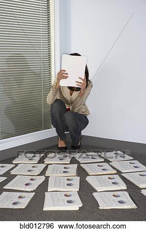 Stock Photograph - Businesswoman hiding face with papers. Fotosearch