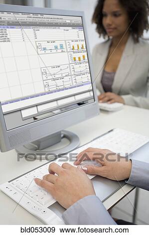 Stock Photo - Businesswoman typing on laptop. Fotosearch