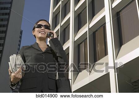 Businesswoman wearing sunglasses talking on cell phone View Large Photo Image Stock Image - Businesswoman wearing sunglasses talking on cell phone. Fotosearch
