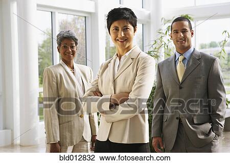 Businesswoman with two coworkers View Large Photo Image Stock Image - Businesswoman with two coworkers. Fotosearch