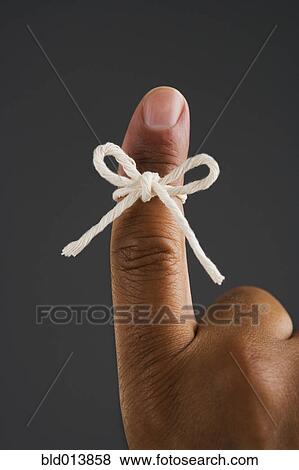 Close up of finger tied in bow View Large Photo Image Stock Photo - Close up of finger tied in bow. Fotosearch