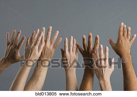Stock Photography - Close up of group of hands raised. Fotosearch