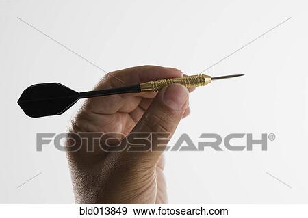 Close up of hand holding dart View Large Photo Image Stock Photo - Close up of hand holding dart. Fotosearch