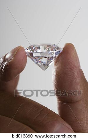 Close up of hand holding diamond View Large Photo Image Stock Image - Close up of hand holding diamond . Fotosearch