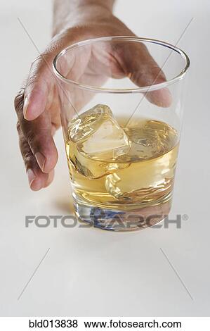 Close up of hand reaching for drink View Large Photo Image Stock Photo - Close up of hand reaching for drink. Fotosearch