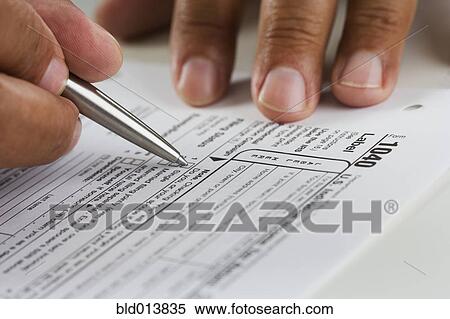Close up of hands filling in tax form View Large Photo Image Stock Photography - Close up of hands filling in tax form . Fotosearch