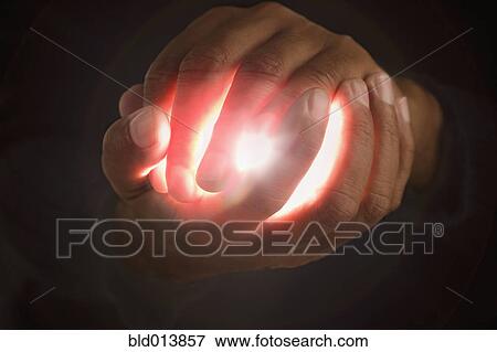 Close up of hands holding light View Large Photo Image Stock Photo - Close up of hands holding light. Fotosearch