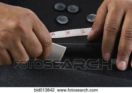 Close up of hands measuring with tape measure View Large Photo Image Stock Image - Close up of hands measuring with tape measure. Fotosearch