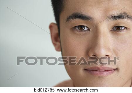 Stock Photography - Close up of young man smiling at camera. Fotosearch