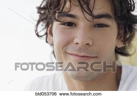 Stock Photograph - Close up of young man smiling. Fotosearch