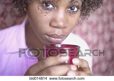 Picture - Close up portrait of woman holding coffee cup. Fotosearch