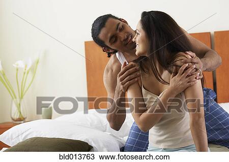 Couple hugging in bed View Large Photo Image Stock Image - Couple hugging in bed. Fotosearch