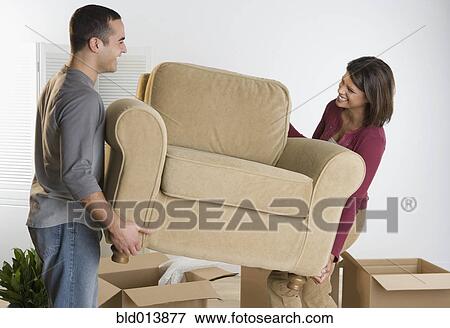 Couple moving chair View Large Photo Image Stock Photo - Couple moving chair. Fotosearch