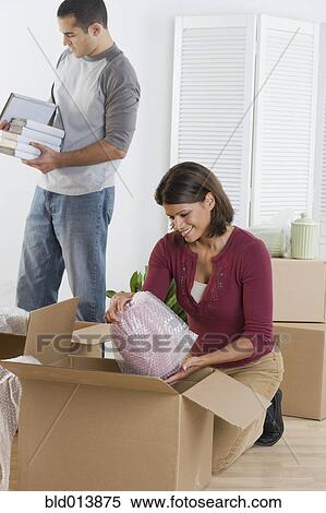 Couple unpacking boxes View Large Photo Image Stock Photography - Couple unpacking boxes. Fotosearch