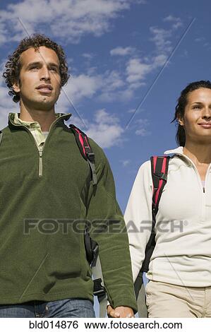 Couple walking while holding hands View Large Photo Image Stock Photograph - Couple walking while holding hands. Fotosearch