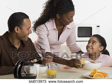 Stock Image - Family eating breakfast together. Fotosearch