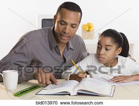 Father helping daughter with homework View Large Photo Image Stock Image - Father helping daughter with homework. Fotosearch