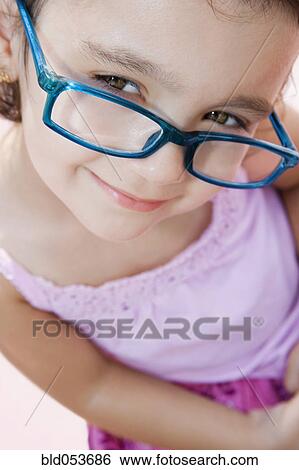Girl wearing eyeglasses View Large Photo Image Stock Photograph - Girl wearing eyeglasses. Fotosearch