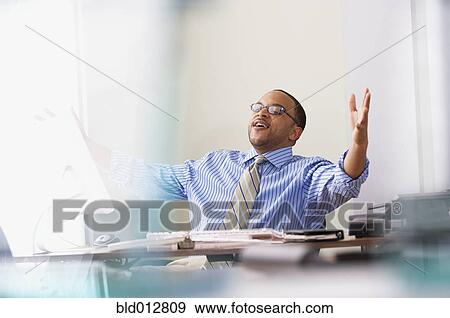 Happy businessman at desk View Large Photo Image Stock Photo - Happy businessman at desk. Fotosearch