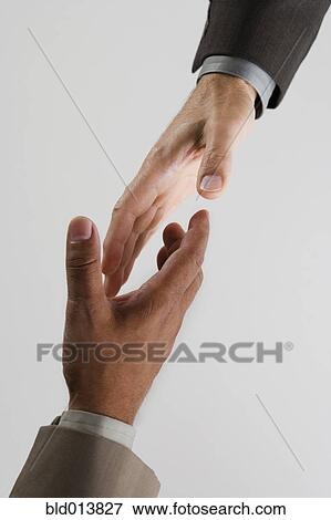 High angle view of businessman's hands shaking View Large Photo Image Stock Photo - High angle view of businessman's hands shaking. Fotosearch