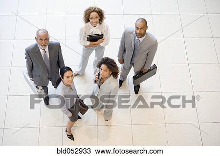 Stock Image - High angle view of Multi-ethnic businesspeople. Fotosearch