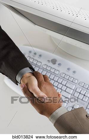 High angle view of two businessman's hands shaking View Large Photo Image Picture - High angle view of two businessman's hands shaking. Fotosearch