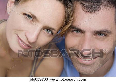 Stock Image - Hispanic couple touching heads. Fotosearch