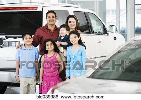 Stock Photograph - Hispanic family at car dealership. Fotosearch