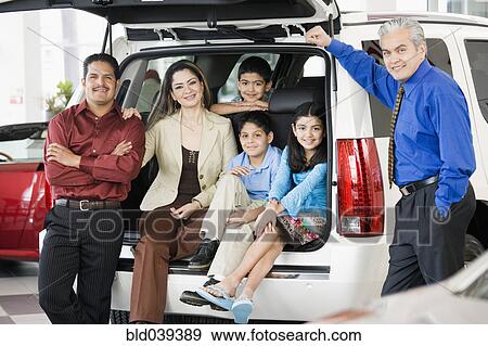 Hispanic family with salesman at car dealership View Large Photo Image Stock Photo - Hispanic family with salesman at car dealership. Fotosearch