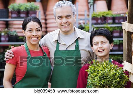 Stock Photo - Hispanic family working at garden center. Fotosearch