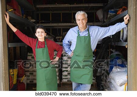 Hispanic father and son working at garden center View Large Photo Image Stock Image - Hispanic father and son working at garden center. Fotosearch
