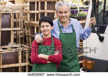 Hispanic father and son working at garden center View Large Photo Image Stock Photo - Hispanic father and son working at garden center. Fotosearch