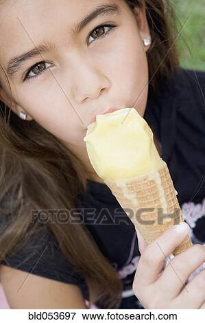 Hispanic girl eating ice cream cone View Large Photo Image Stock Photo - Hispanic girl eating ice cream cone. Fotosearch