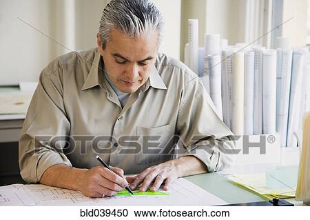 Hispanic male architect writing at desk View Large Photo Image Stock Image - Hispanic male architect writing at desk. Fotosearch