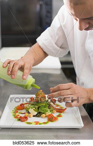 Hispanic male chef preparing food View Large Photo Image Stock Photography - Hispanic male chef preparing food. Fotosearch