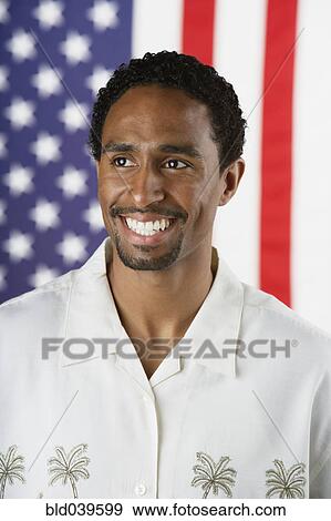 Hispanic man standing in front of American flag View Large Photo Image Stock Photo - Hispanic man standing in front of American flag. Fotosearch